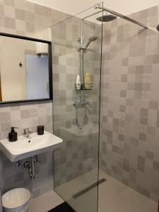 a bathroom with a sink and a shower at Apartments Ela in Neum +35 photos
