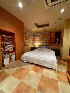 a bedroom with a bed and a refrigerator at フラン in Iwamizawa +18 photos