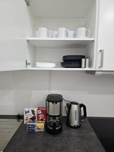 a coffee maker sitting on a counter in a kitchen at SFN Home Stay in Bergisch Gladbach