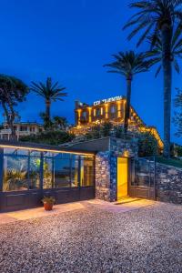 a house with palm trees on top of it at Hotel Continental in Santa Margherita Ligure