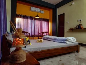 a bedroom with a bed with a table and a window at Hostel Osara in Bodh Gaya