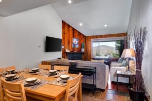 a dining room and living room with a table and chairs at SNOW FLOWER 029 condo in Park City +46 photos