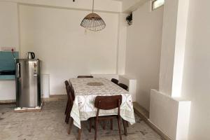 a kitchen with a table with chairs and a refrigerator at One Bedroom in C-Scheme, Jaipur in Jaipur