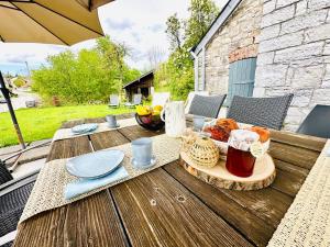 a wooden table with a plate of food on it at L'Héritage de Durbuy in Durbuy