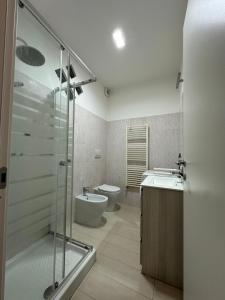 a bathroom with a shower and a toilet and a sink at la corte di seba milano malpensa in Cardano al Campo