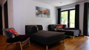 a living room with a couch and a chair at Ferienwohnung-Claudia in Schwerin in Schwerin