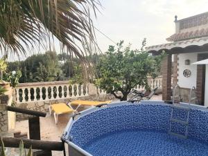 un jacuzzi azul sentado en un patio en Villa Capricho Nerja, en Málaga