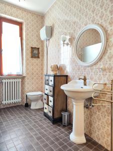 a bathroom with a sink and a toilet and a mirror at Casa Agello B&B in Ripatransone