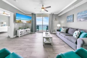 a living room with a couch and a table at Tidewater 2308 by Emerald Coast Retreats in Panama City Beach +79 photos