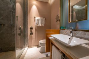a bathroom with a sink and a shower and a toilet at WISDOM Boutique Hotel in Beijing