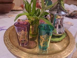 a group of different colored glass vases on a table at Le Chêne d´Azrou in Azrou