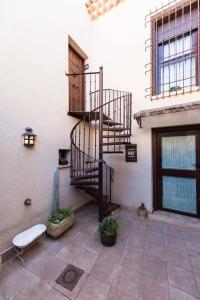 a spiral staircase in a building with a bench at Casa Rural Bellamonte in Belmonte
