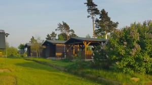 Cabaña de madera en un patio con césped verde en Ośrodek wczasowy Raciąż, en Raciąż
