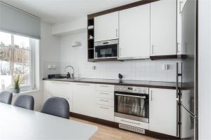 a kitchen with white cabinets and a counter top at KungsbergetNatur in Järbo +20 photos