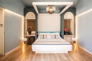 a bedroom with a large bed with blue walls at Hotel New Barcavela in Santa Margherita di Pula +167 photos