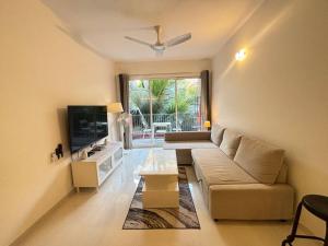 Elegant 2 BHK, Pool Front, Zennova Stays的电视和/或娱乐中心