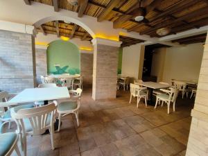 莫尔穆冈Elegant 2 BHK, Pool Front, Zennova Stays的一间有桌椅的餐厅