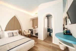 a bedroom with a bed and a desk at New Barcavela in Santa Margherita di Pula