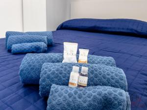 a blue bed with two pillows on top of it at Sea 3 min - Trains 8 - min - Free WiFi - AC in Albisola Superiore
