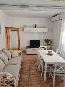 a living room with a couch and a table at Apartman Ljubo in Podgora