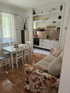 a living room with a couch and a table at Apartman Ljubo in Podgora