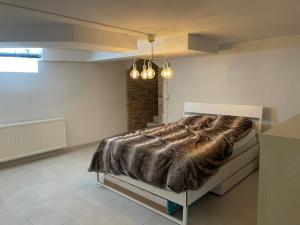 a bedroom with a bed with a faux fur blanket at New flat in Limhamn in Limhamn