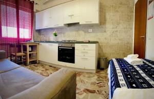 a kitchen with white cabinets and a stove top oven at Blue Deluxe Venice in Mestre