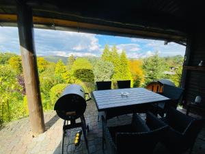 a table and chairs on a patio with a view at Dachsbau in Barbis