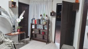 a living room with a book shelf with books at Posada de Mary in Sucre