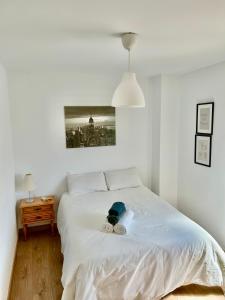 ein Schlafzimmer mit einem weißen Bett und Handtüchern darauf in der Unterkunft El Txoko Andaluz in Cantillana