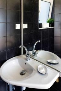 a white sink in a bathroom with a mirror at The Terrace with Acropolis & Athens view in Athens