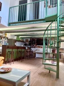 a kitchen with a green spiral staircase in a building at El Txoko Andaluz in Cantillana +39 photos