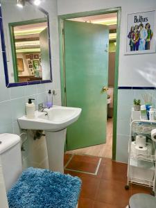 a bathroom with a sink and a shower with a mirror at El Txoko Andaluz in Cantillana