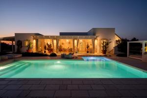 uma piscina em frente a uma casa à noite em Villa Lucia con piscina privata vicino al mare em Gallipoli