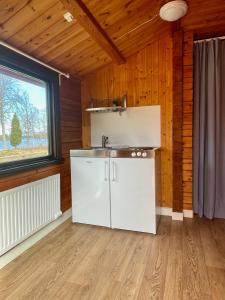 a kitchen with a sink in a room with a window at Urshult Camping in Urshult +32 photos