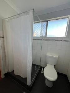 a bathroom with a white toilet and a shower at Katherine Motel in Katherine