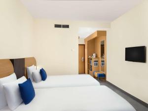 Postel nebo postele na pokoji v ubytování Novotel Budapest Danube