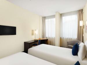 Postel nebo postele na pokoji v ubytování Novotel Budapest Danube