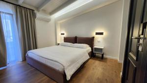 a bedroom with a large bed and a window at Old Town Villa in Durrës