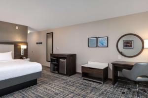 a hotel room with a bed and a desk at Hampton Inn & Suites Manteca in Manteca