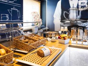 a kitchen with bread and other food on a counter at ibis budget Ludwigsburg -RENOVIERT IN 2024!- in Ludwigsburg