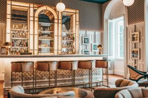a bar in a restaurant with bar stools at Hilton Imperial Dubrovnik in Dubrovnik