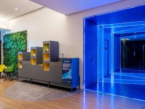 an exhibit in a room with a blue wall at Pullman Sao Paulo Guarulhos Airport in Guarulhos