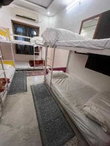 Pokój z 2 łóżkami piętrowymi i 2 dywanami w obiekcie Hotel Dara & Camel Safari w mieście Jaisalmer