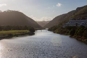 a view of a river with mountains in the background at Casa da Calçada in Maceira