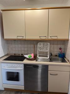a kitchen with a stove and a sink at Ferienwohnung in Binz an der Granitz in Binz
