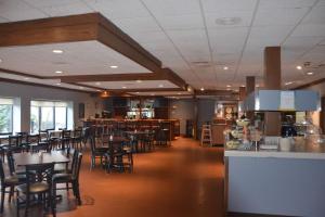 a restaurant with tables and chairs and a bar at Quality Inn in Perrysburg