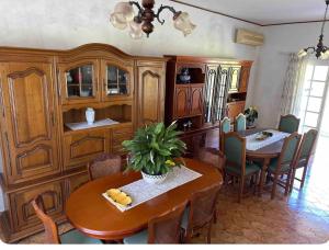 a kitchen and dining room with a table and chairs at Villa des écuries BENARD in Sainte-Suzanne