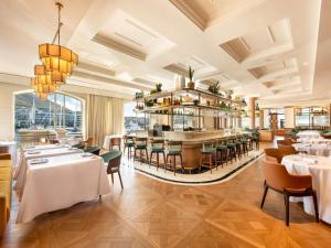 een restaurant met tafels en stoelen en een bar bij Cape Grace, A Fairmont Managed Hotel in Kaapstad
