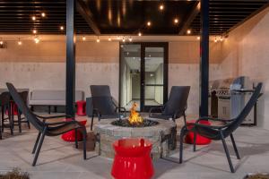 a fire pit with chairs and a table and a grill at Home2 Suites By Hilton Jacksonville Downtown in Jacksonville